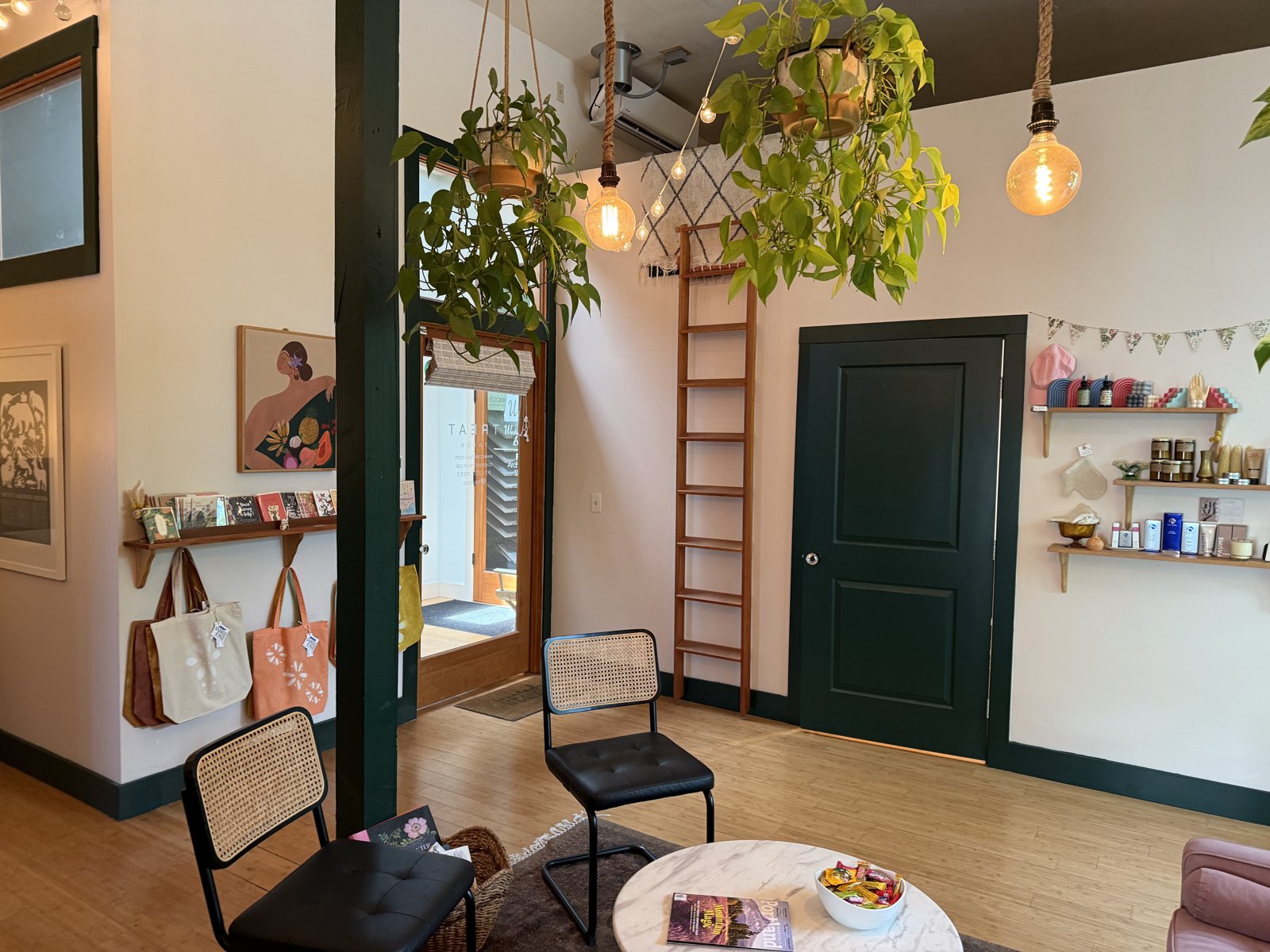Treat salon lounge — hanging plants, tote bags, product shelves